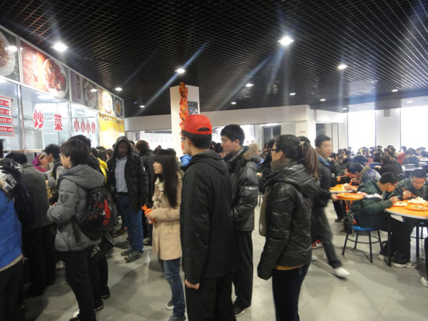 2、志愿者们在学生活动中心一层食堂组织同学们排队就餐.JPG